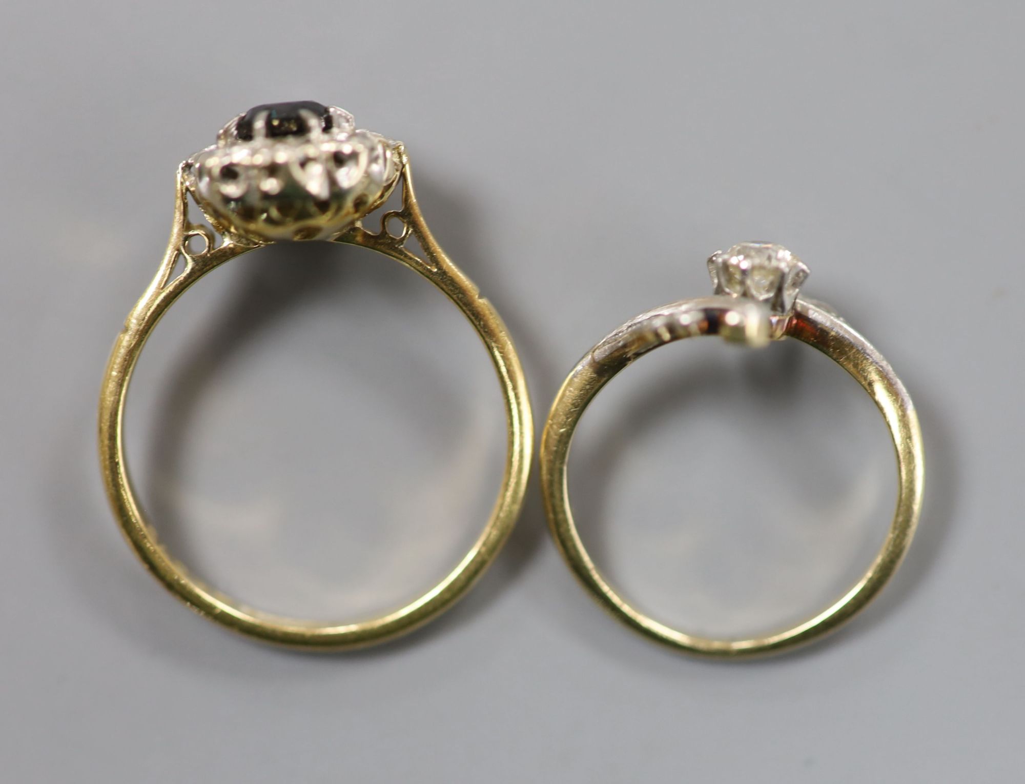 A 585 yellow metal and diamond set crossover ring, size J, gross 2 grams and one other ring.